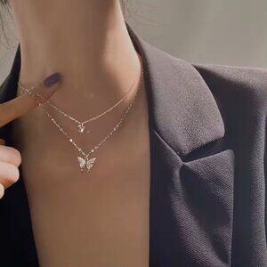 Double butterfly is a centerpiece of this trendy necklace pave-set with AAA CZ's